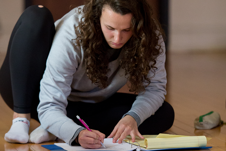 Student writing in a notebook