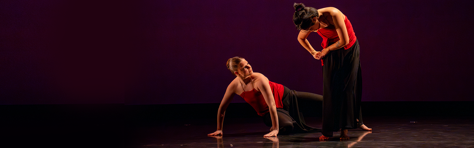 performers in red on a stage